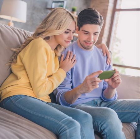 Paar auf Sofa mit Smartphone